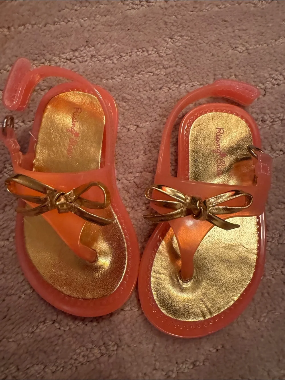 Rising Star Coral Jelly Sandals with Metallic Gold Bow Accent